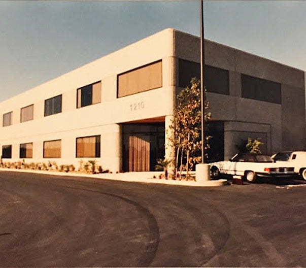 Commercial building with cars parked in front on a clear day