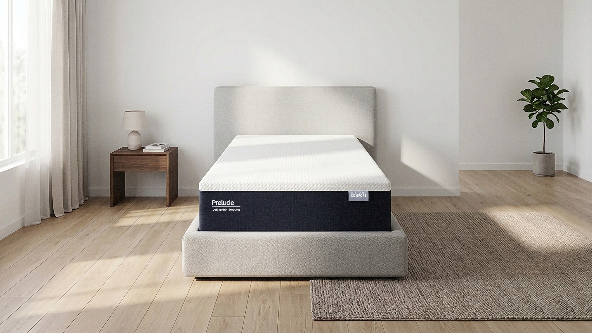 Mattress on a bed in a room with a side table and plant