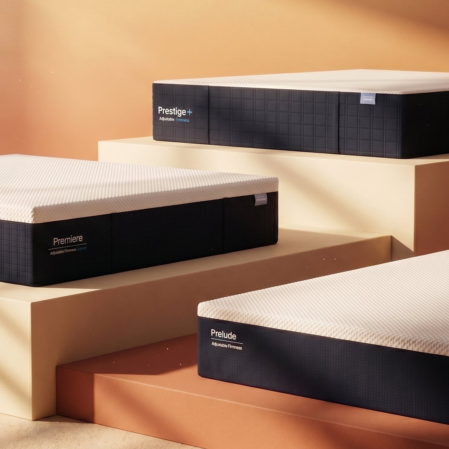 Three mattresses labeled 'Prestige+', 'Premiere', and 'Prelude' on a beige platform.