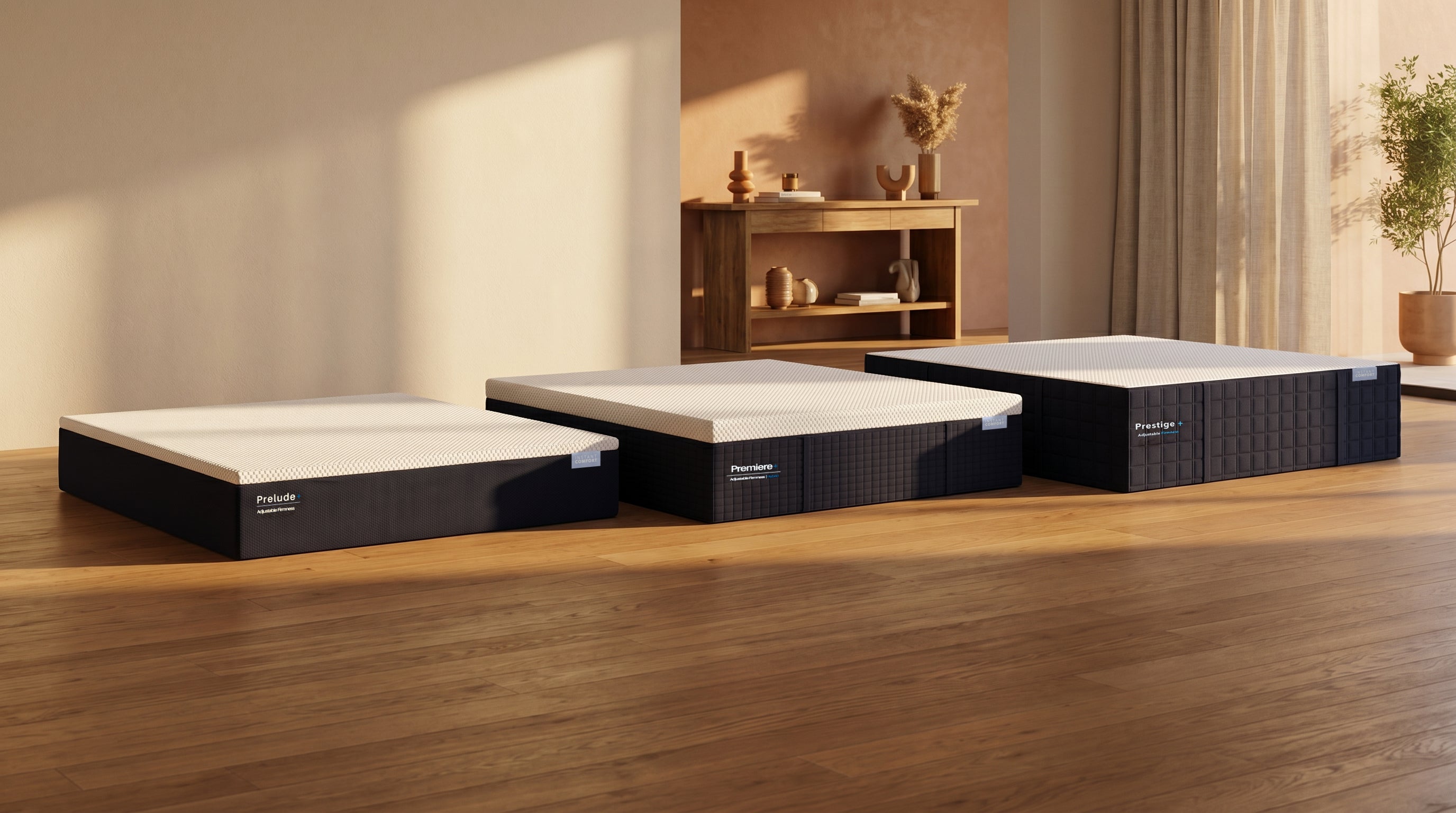Three mattresses on a wooden floor with a neutral-colored wall and decorative items in the background.