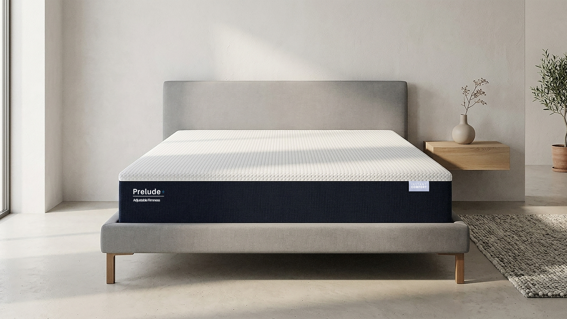 Prelude mattress on a bed in a minimalistic room with a neutral color scheme.