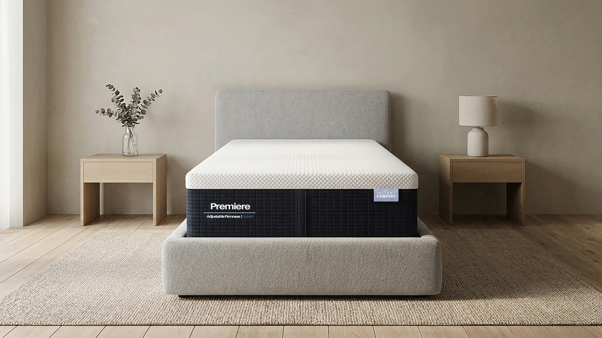 Gray mattress with 'Premier' branding on a wooden floor in a minimalistic room.