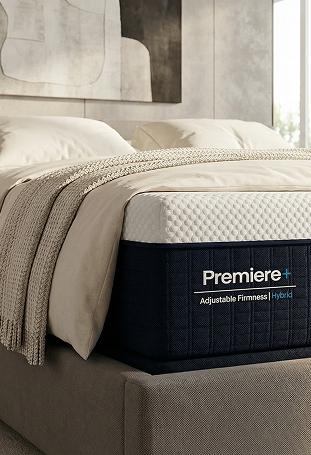 Premiere hybrid mattress in a bedroom setting with bedding and headboard.