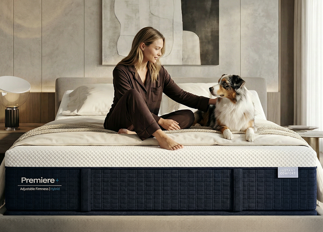 Woman sitting on a Premier mattress with a dog in a bedroom setting